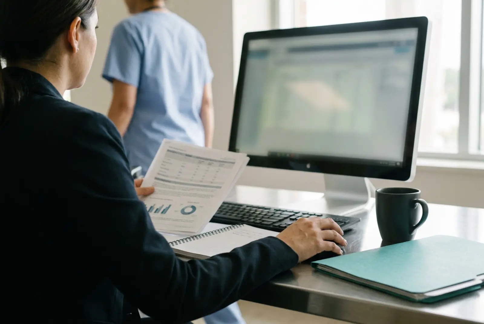Healthcare Data Integration: healthcare data analyst reviewing patient flow dashboards on a monitor in a hospital administrative office, sc